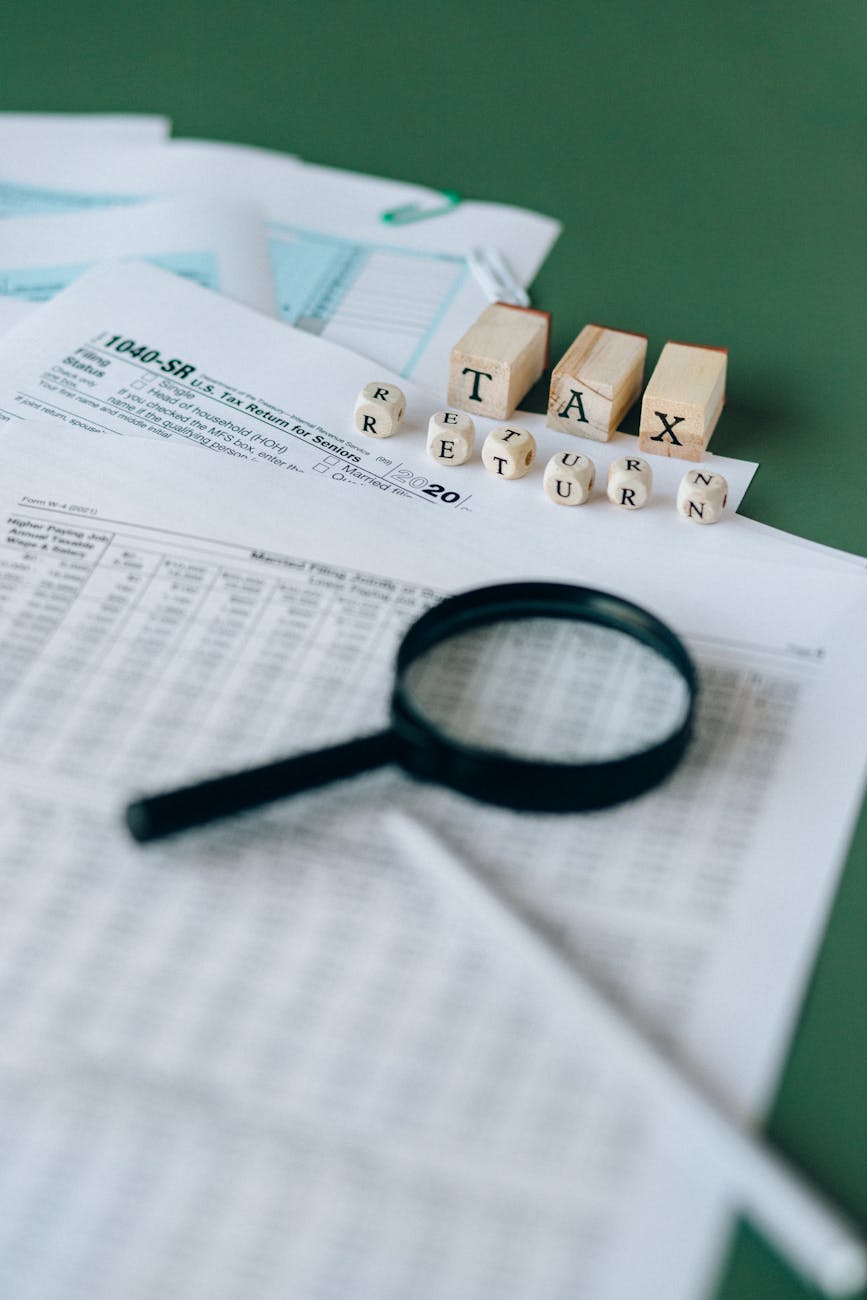 magnifying glass on top of tax documents